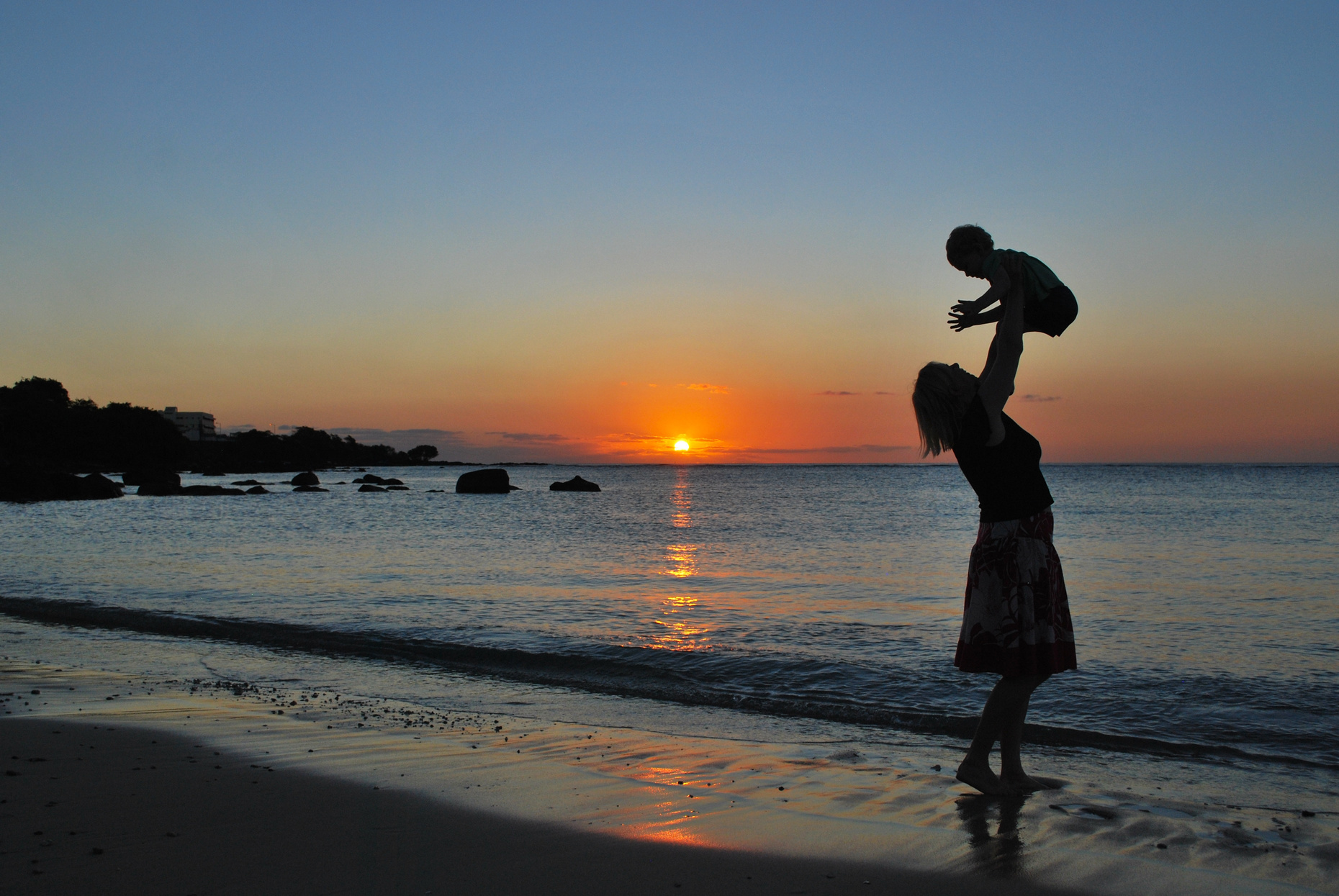 Silhouette of Mother and Child at the Beach